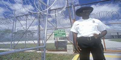 Prison Guard Standing Outside of a Correctional Facility