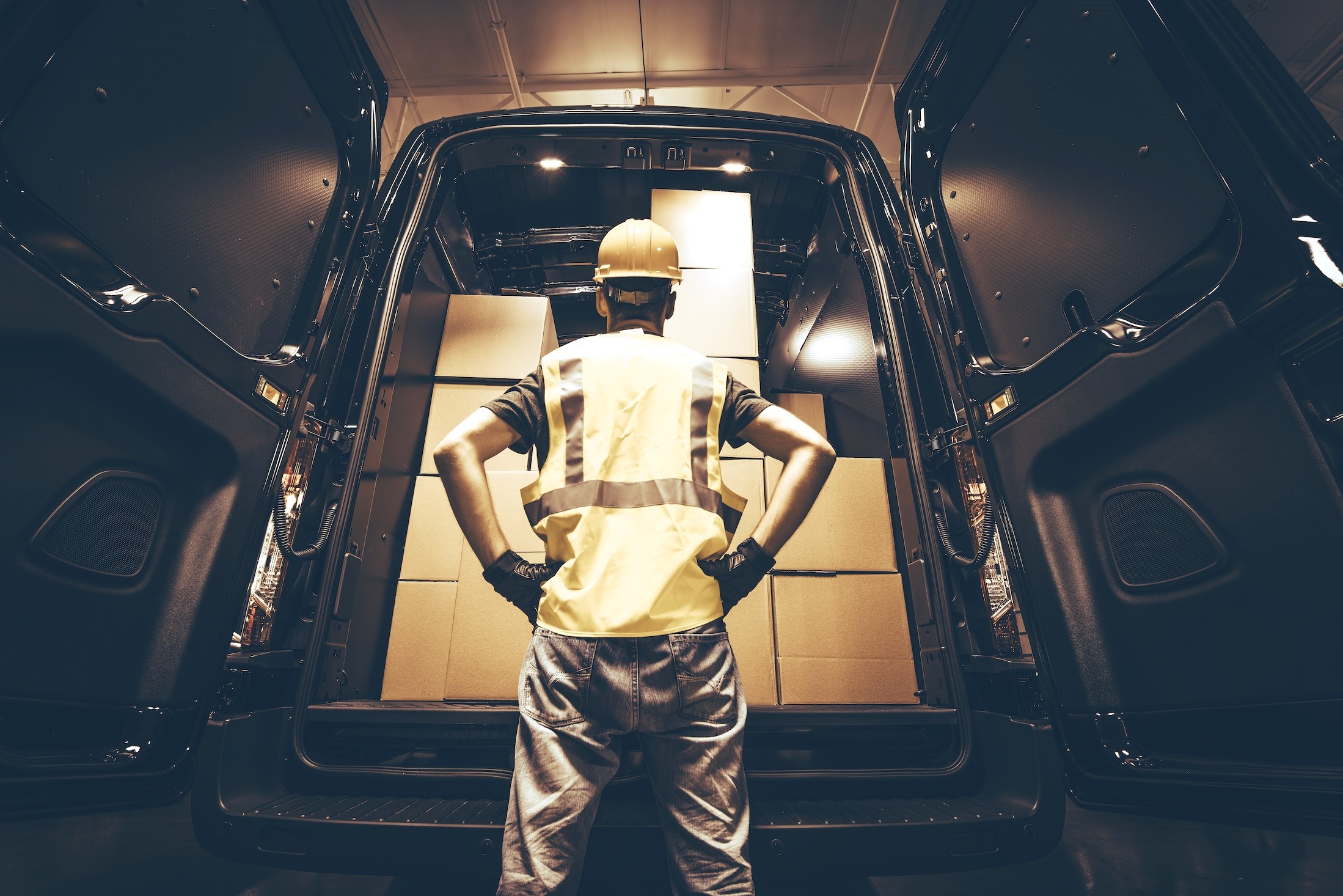 Customs Agent Analyzing Boxes in the Back of a Van