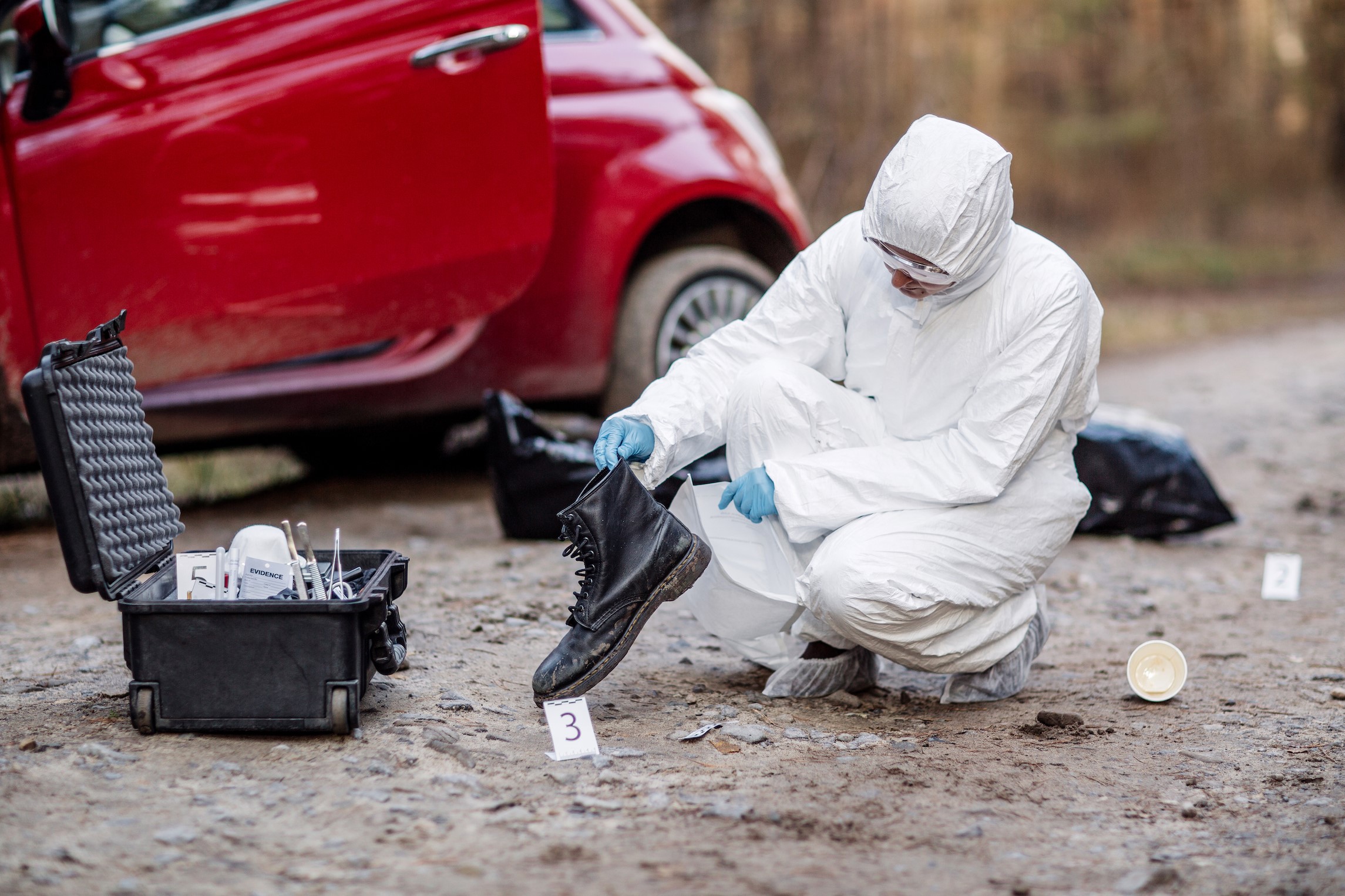 Forensic Technician Analyzing Evidence at a Crime Scene