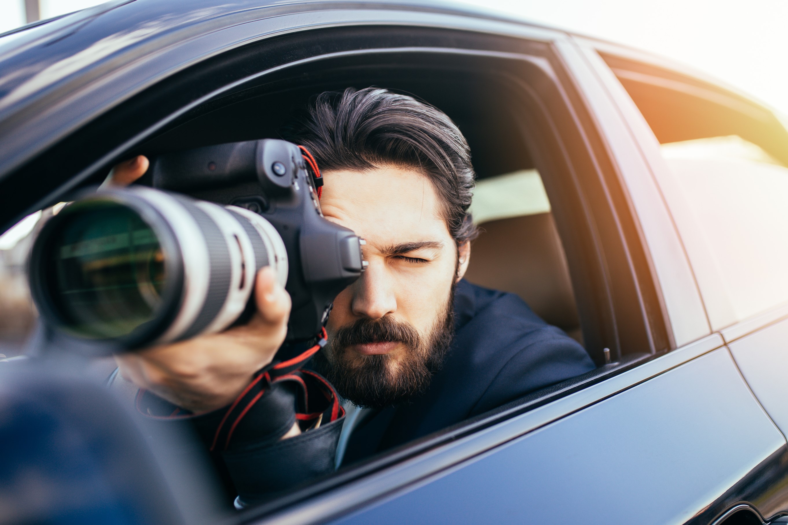 Private Investigator Capturing Photos from His Car