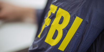 FBI-agent-featured-image - Criminal Justice Programs Close-up of a navy blue FBI jacket with yellow lettering