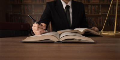 lawyer reading law books to advice client