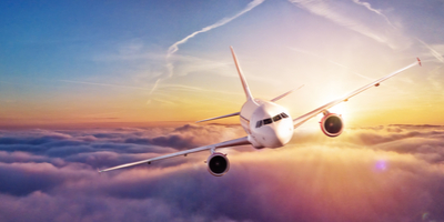 airplane in sky during sunset