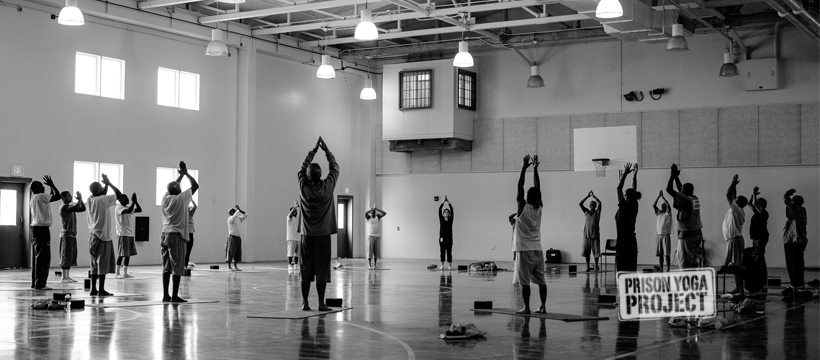 Group of men doing yoga in a gym