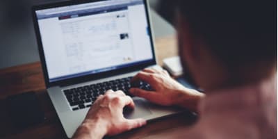 Man typing on a laptop